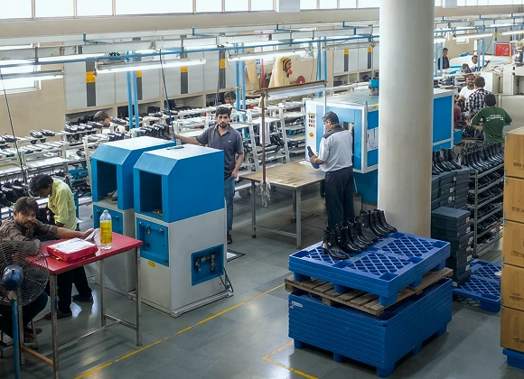 Production floor at the Foot On Shoes factory in Agra, with operators assembling leather boots